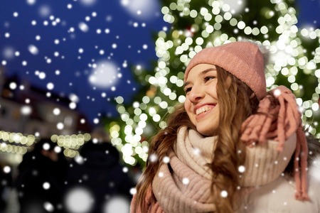 happy young woman at christmas market in winterの写真素材