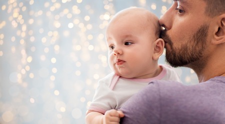 Close up of father kissing little baby daughterの写真素材