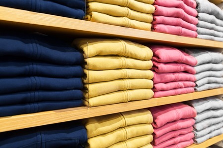 Close up of shelves with clothes at clothing store