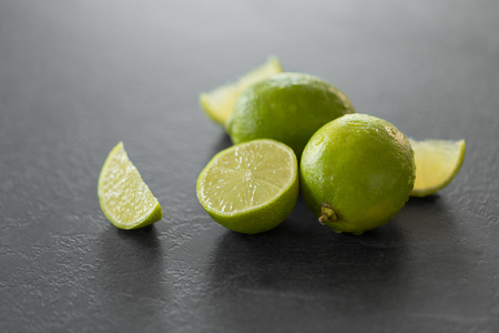 close up of limes on slate table topの写真素材