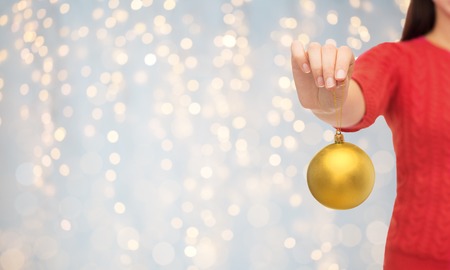 close up of woman in sweater with christmas ballの写真素材