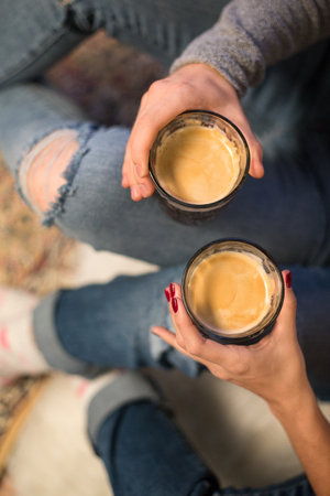 close up of couple with coffee glasses at homeの写真素材