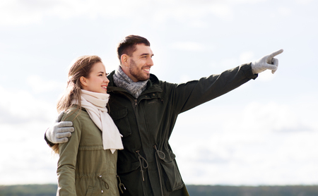 smiling couple hugging on autumn beachの写真素材