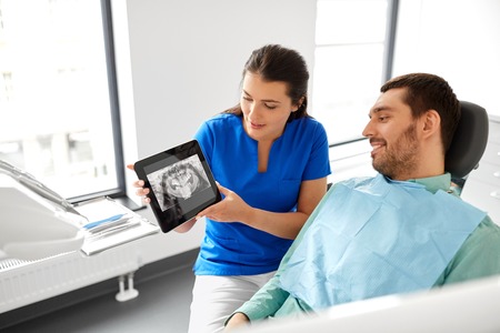 dentist showing panoramic dental x-ray to patientの写真素材