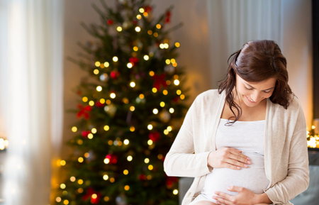 happy pregnant woman at home on christmasの写真素材