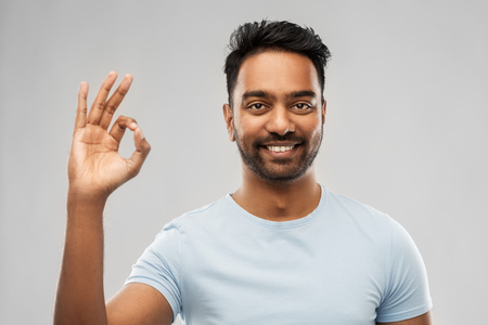 happy indian man in t-shirt showing ok hand signの写真素材