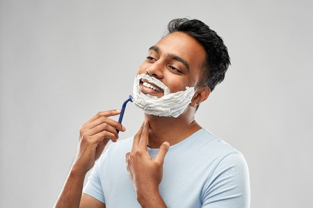 indian man shaving beard with razor bladeの写真素材