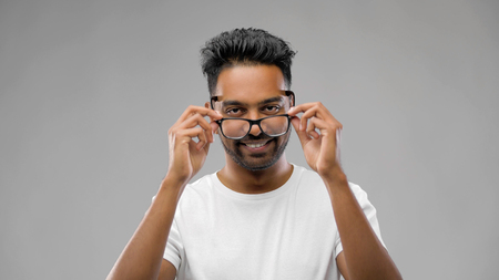 happy indian man in eyeglasses or studentの写真素材