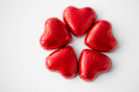 close up of red heart shaped chocolate candiesの写真素材