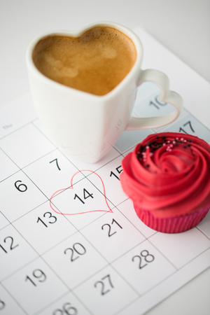 close up of calendar, coffee, cupcake and heartの写真素材