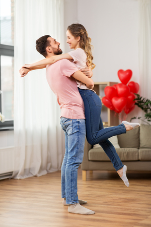 happy couple at home on valentines dayの写真素材