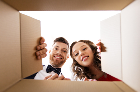 happy couple opening christmas gift boxの写真素材