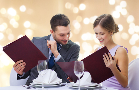 couple with menus at restaurantの写真素材
