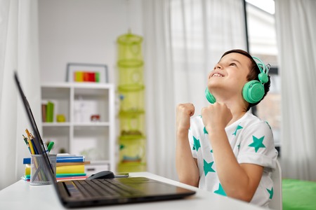 boy celebrating victory in computer video game