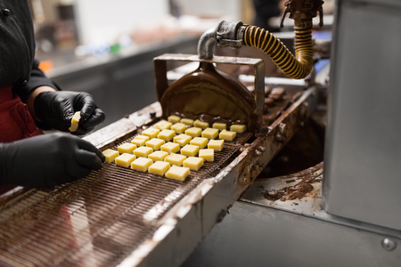 confectioner with chocolate coating machineの写真素材