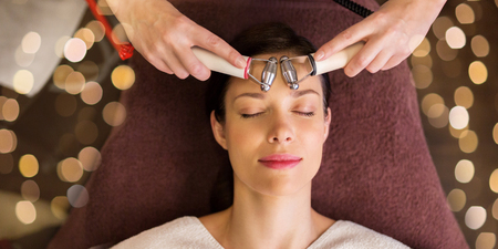 woman having hydradermie facial treatment in spa