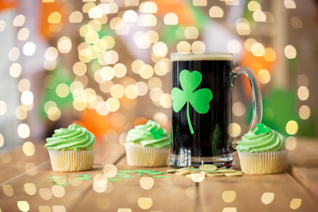 shamrock on glass of beer, green cupcake and coinsの写真素材