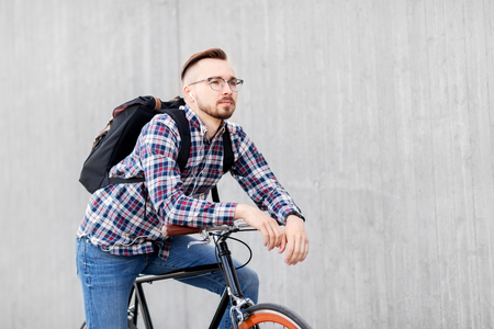 hipster man with fixed gear bike and backpackの写真素材