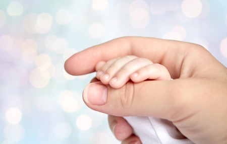 close up of mother and newborn baby handsの写真素材