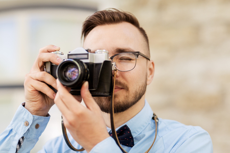 photographer or hipster with film camera outdoorsの写真素材