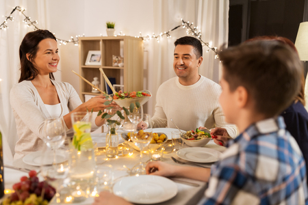celebration, holidays and people concept - happy family having dinner party at homeの写真素材
