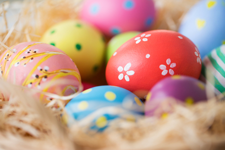 close up of colored easter eggs in strawの写真素材