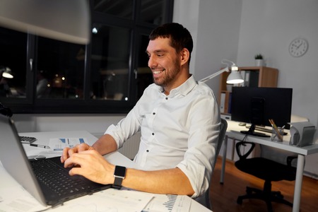 businessman with laptop working at night office