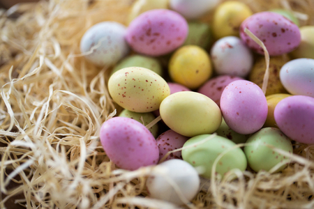 close up of easter egg candies in straw nestの写真素材