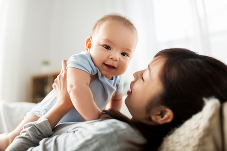 happy mother with little baby son at homeの写真素材