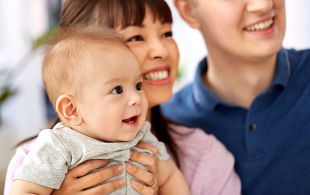 close up of happy mixed-race family with baby sonの写真素材