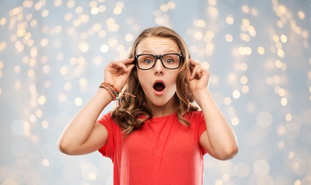 surprised or shocked teenage girl in glasses