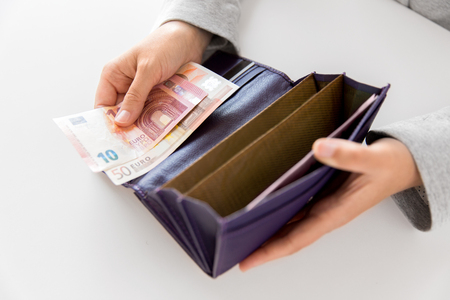 close up of woman hands with wallet and euro moneyの写真素材