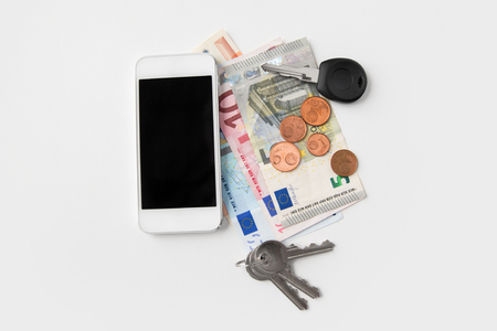 close up of smartphone, euro money and keysの写真素材