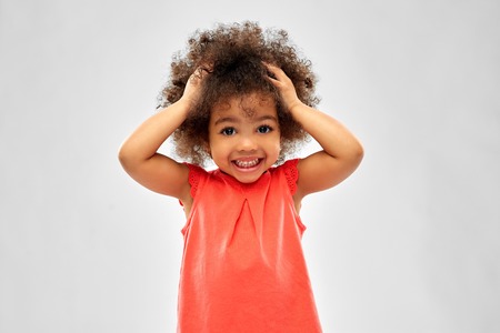 overwhelmed african american girl holding to headの写真素材