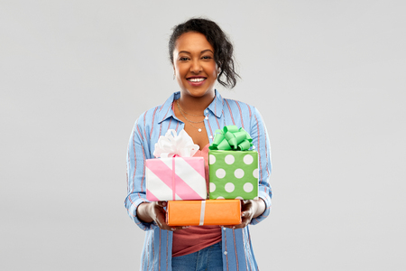 Happy African American woman with birthday giftsの写真素材