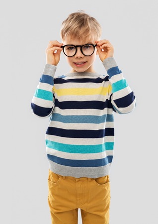 Smiling boy in glasses and striped pulloverの写真素材
