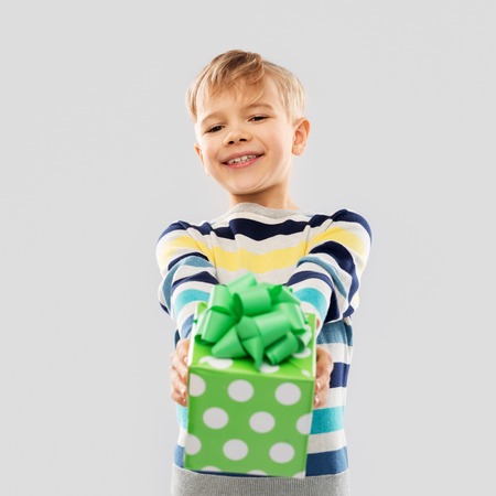 Smiling boy with birthday gift boxの写真素材