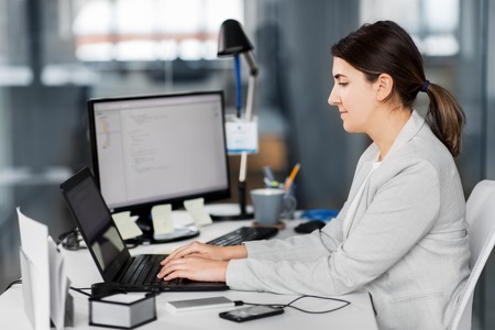 Businesswoman with computer working at officeの写真素材