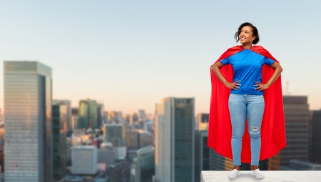 happy african american woman in superhero red capeの素材 [FY310121356465]