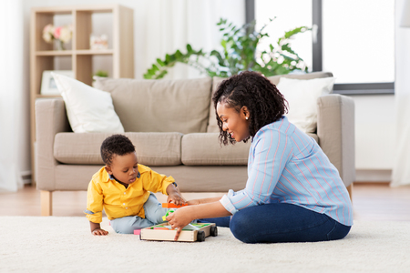 mother and baby playing with toy blocks at homeの写真素材