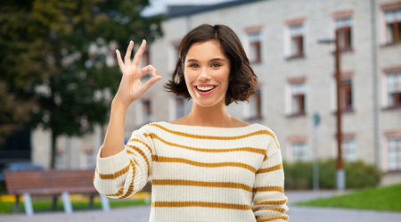 Happy smiling woman or student girl showing okの写真素材