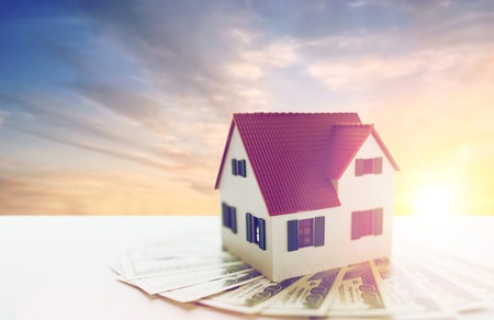 close up of home or house model and money