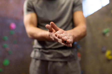 Male climber drying hands at indoor climbing gymの写真素材