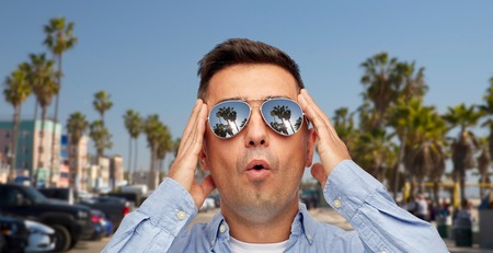 summer holidays, vacation and emotions concept - face of surprised middle aged latin man in...