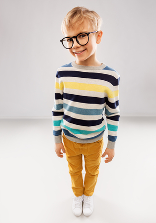 smiling boy in glasses and striped pulloverの写真素材