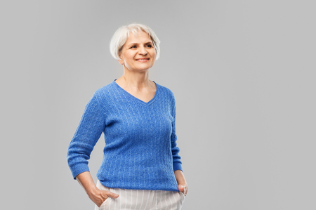 portrait of smiling senior woman in blue sweaterの写真素材