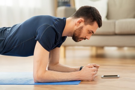 man doing plank exercise at home