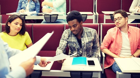 teacher giving tests to students at lectureの写真素材