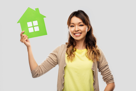 happy asian woman with green houseの写真素材