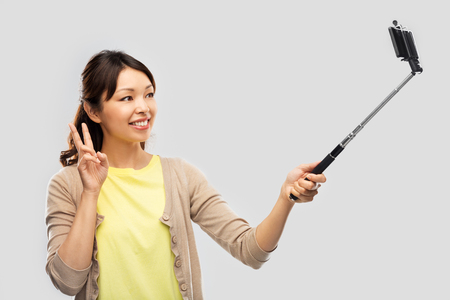 asian woman taking selfie by smartphoneの写真素材